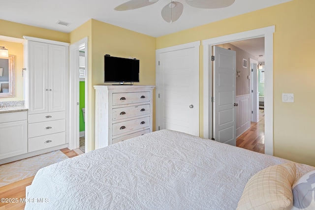 bedroom with light hardwood / wood-style floors and ceiling fan