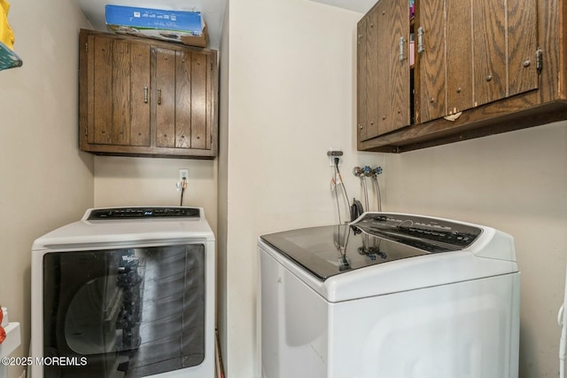 washroom featuring washer and dryer and cabinets