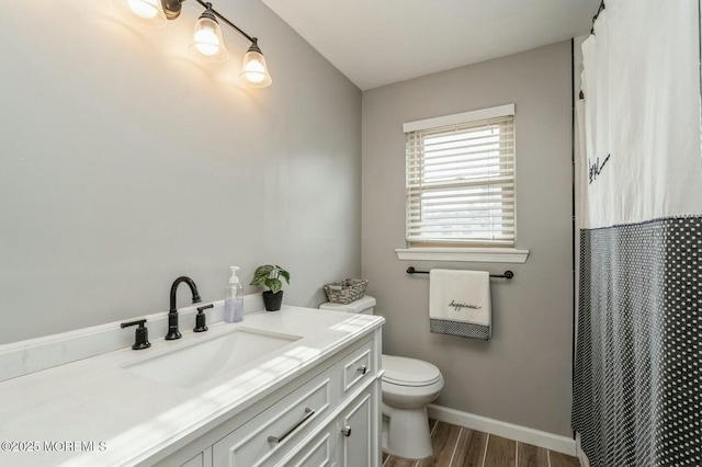 bathroom with vanity, hardwood / wood-style flooring, curtained shower, and toilet