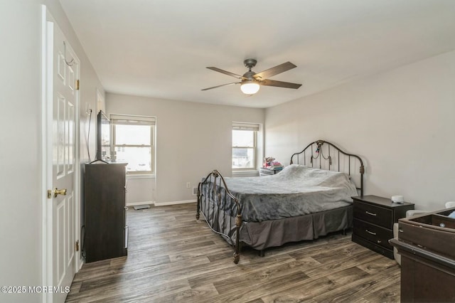 bedroom with dark hardwood / wood-style floors and ceiling fan