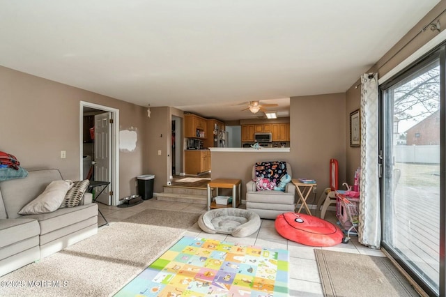 living room featuring ceiling fan and light tile patterned flooring