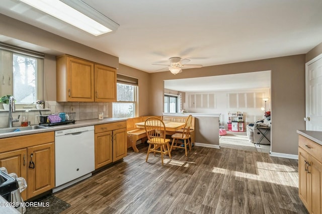 kitchen with sink, stainless steel range, dark hardwood / wood-style floors, dishwasher, and decorative backsplash