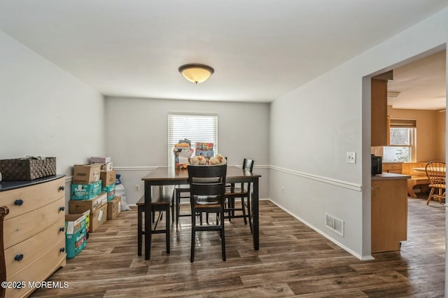 dining room with dark hardwood / wood-style flooring