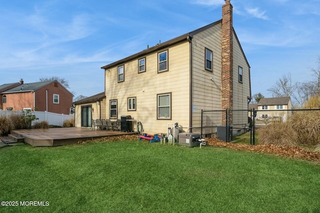 back of house featuring a wooden deck, a yard, and cooling unit