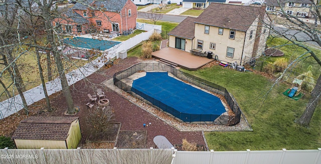 view of pool featuring a lawn