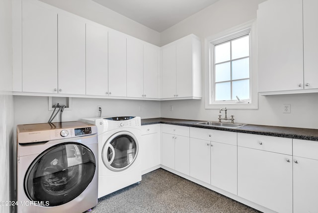 laundry area with separate washer and dryer, sink, and cabinets