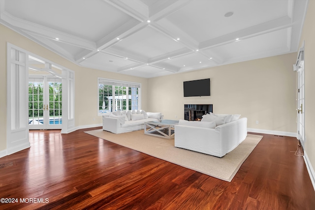 unfurnished living room featuring beamed ceiling, coffered ceiling, dark hardwood / wood-style floors, and french doors