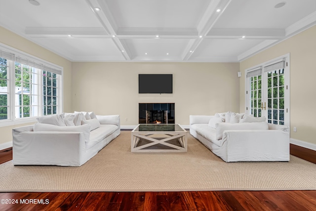 living room with coffered ceiling, plenty of natural light, a tile fireplace, and wood-type flooring