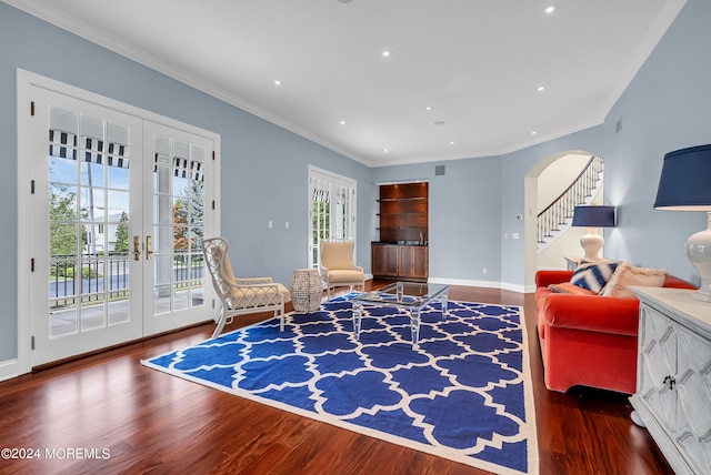 interior space featuring dark hardwood / wood-style flooring, ornamental molding, and french doors