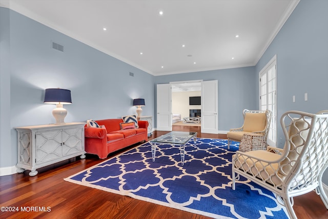 living room featuring crown molding and hardwood / wood-style floors