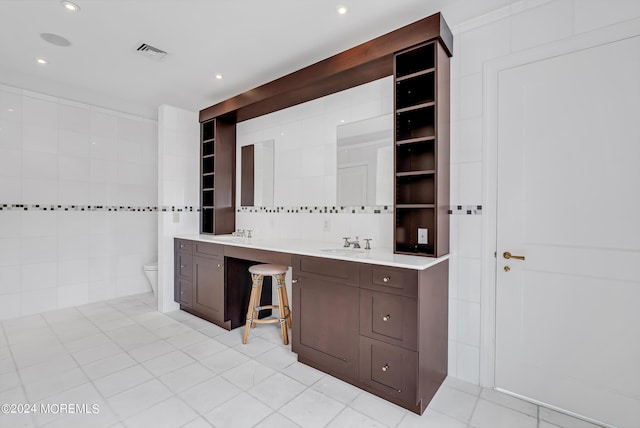 bathroom featuring tile walls, vanity, and toilet