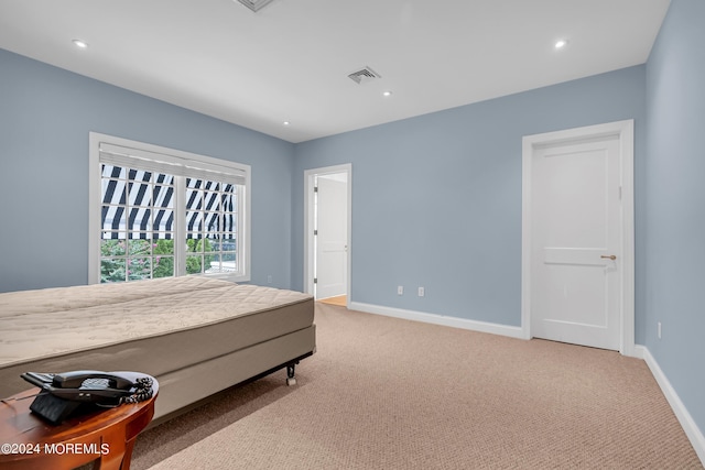 bedroom featuring light carpet