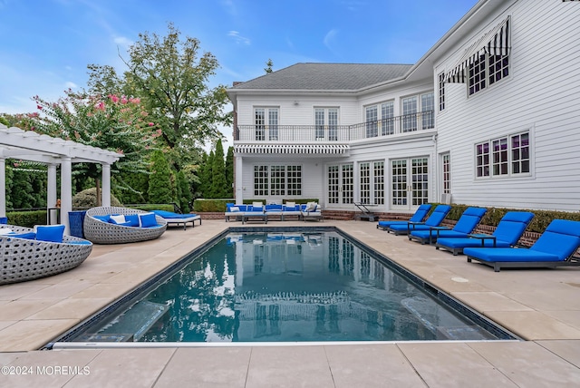 view of pool featuring french doors, an outdoor hangout area, a pergola, and a patio area