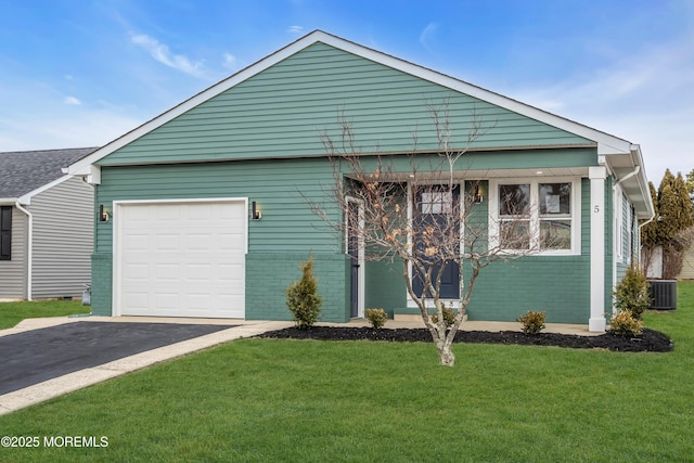 view of front of house with a garage, a front lawn, and central air condition unit