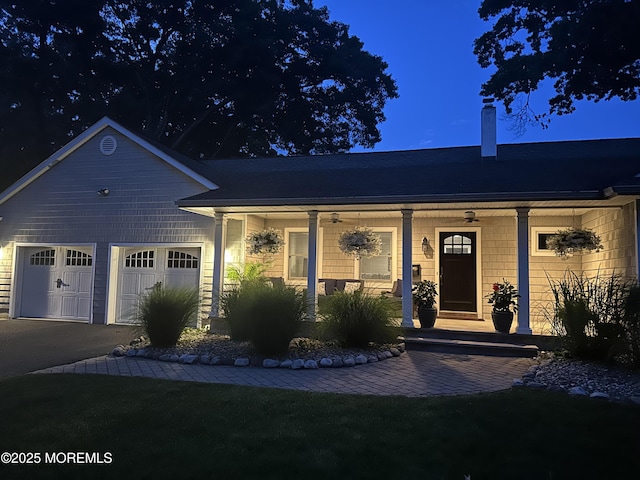 ranch-style home with a garage and a porch