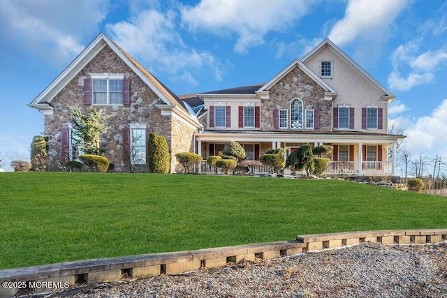 view of front facade with a front yard and covered porch