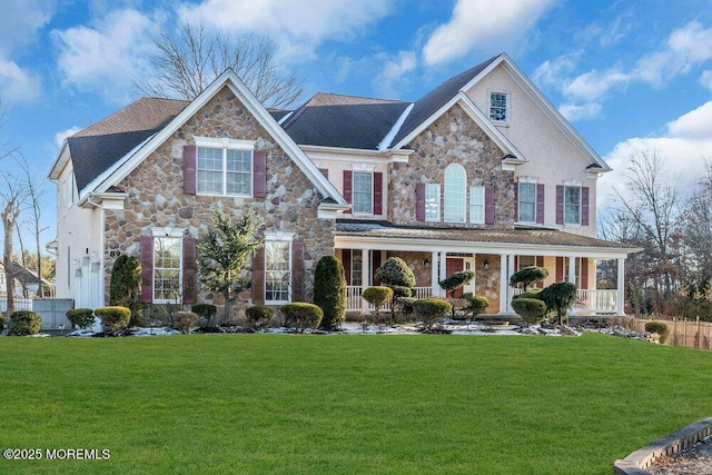 view of front of home with a porch and a front lawn