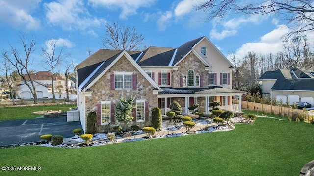 view of front of property featuring covered porch and a front lawn