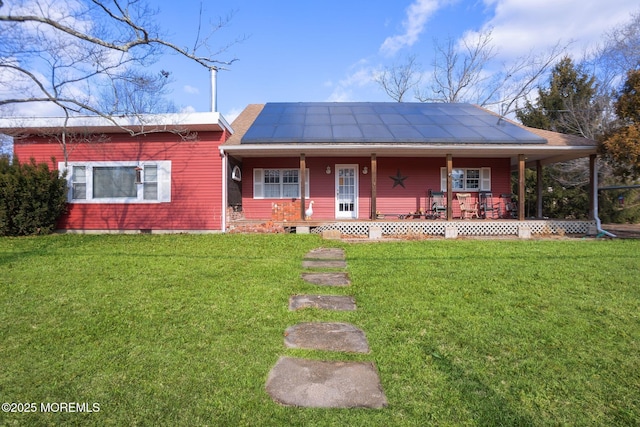 ranch-style house with a front lawn, solar panels, and a porch