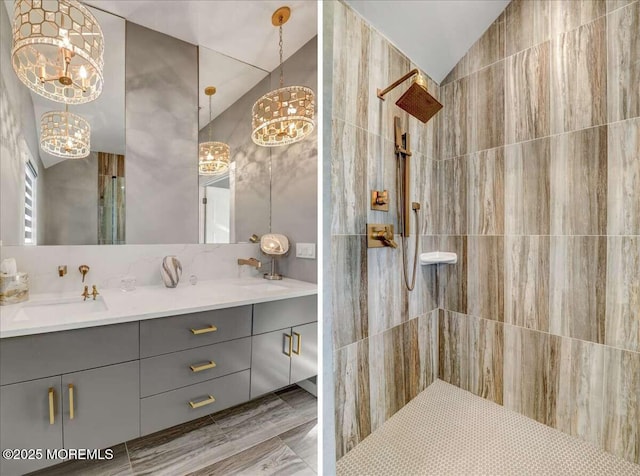 bathroom with vanity, vaulted ceiling, and an inviting chandelier