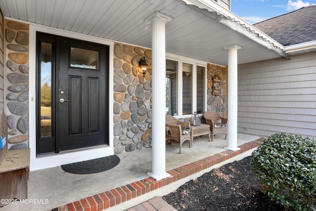 view of exterior entry with covered porch