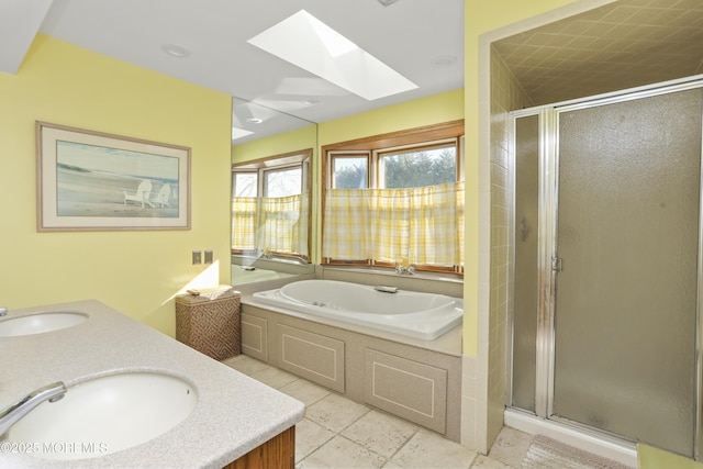 bathroom with vanity, a skylight, and plus walk in shower