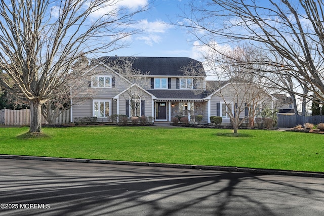 colonial home featuring a front yard