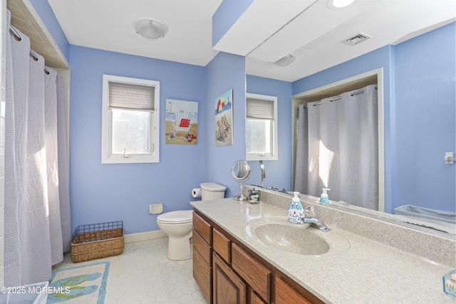 bathroom with tile patterned floors, vanity, and toilet