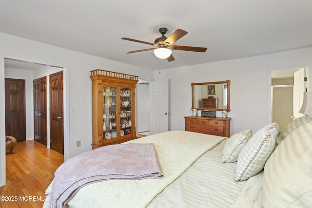 bedroom with ceiling fan and light hardwood / wood-style flooring