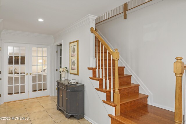 staircase featuring french doors, ornamental molding, and tile patterned flooring