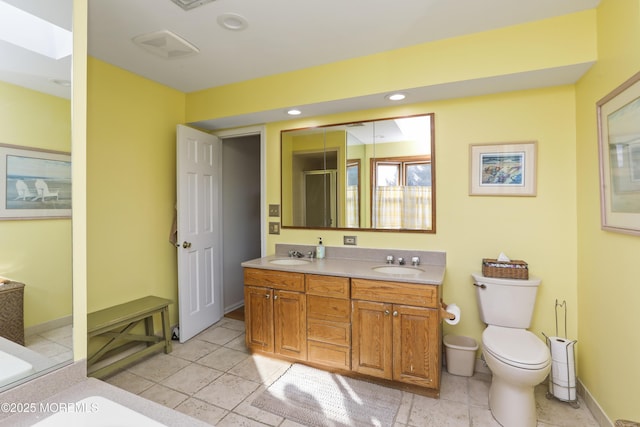 bathroom featuring vanity, toilet, and a shower with shower door