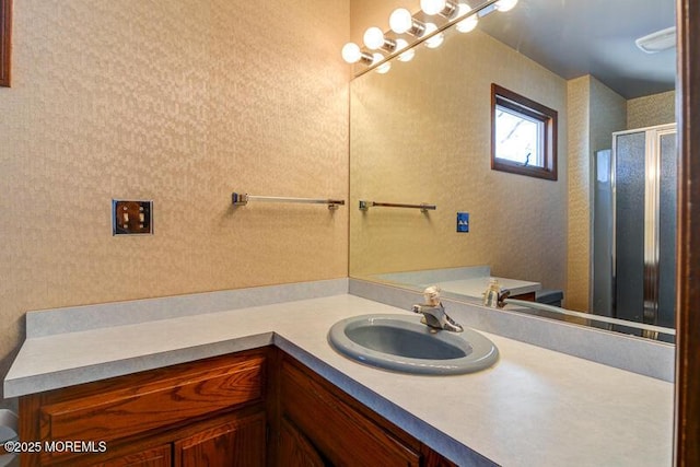 bathroom with walk in shower and vanity