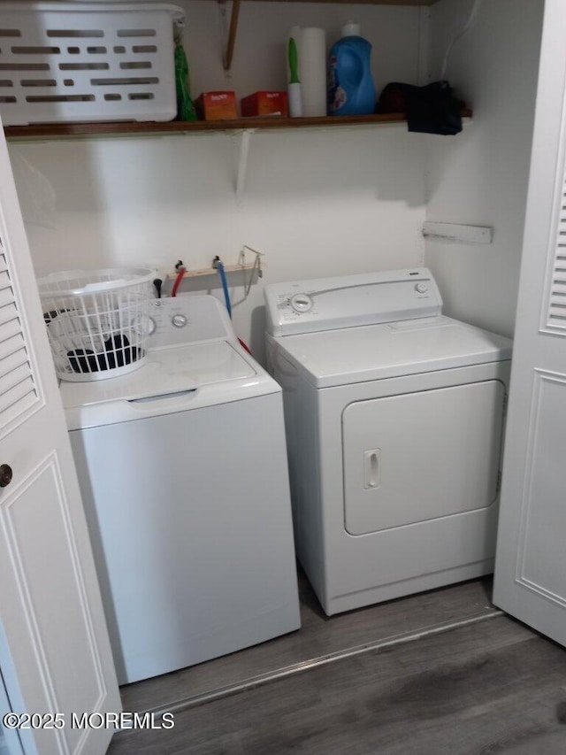 laundry area featuring separate washer and dryer and dark wood-type flooring