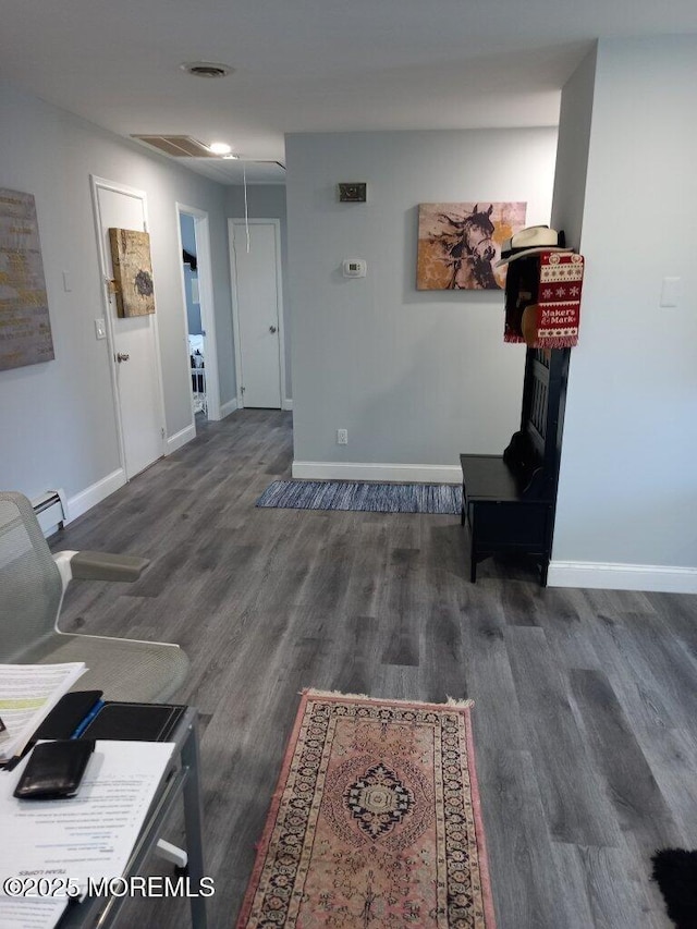 interior space featuring a baseboard radiator and dark wood-type flooring