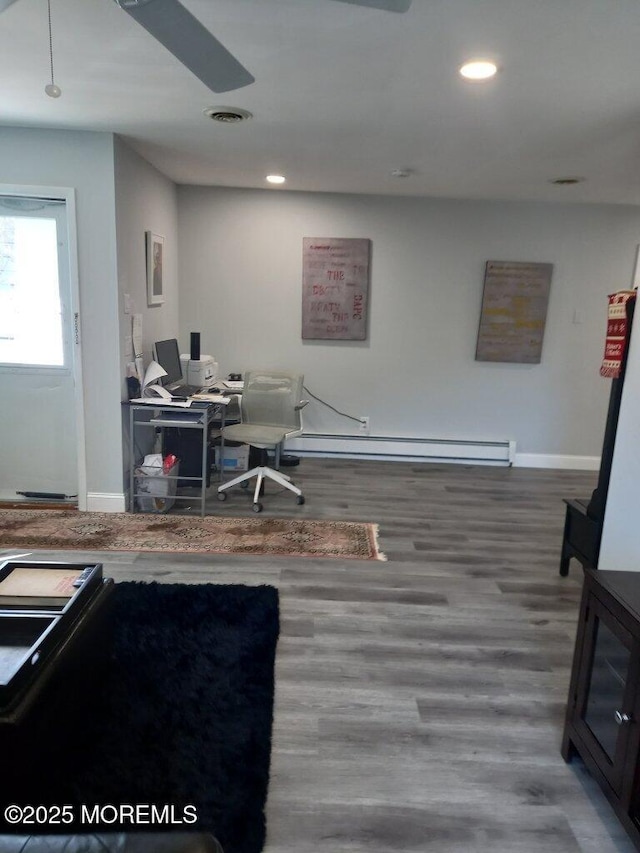 office with wood-type flooring, ceiling fan, and a baseboard radiator