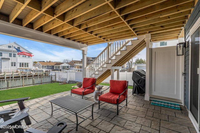 view of patio / terrace with area for grilling and a water view