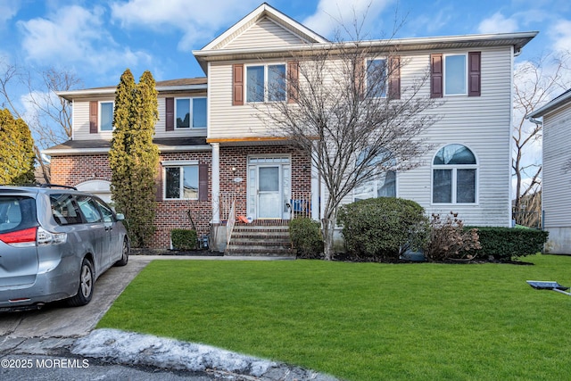 view of front of house with brick siding and a front yard