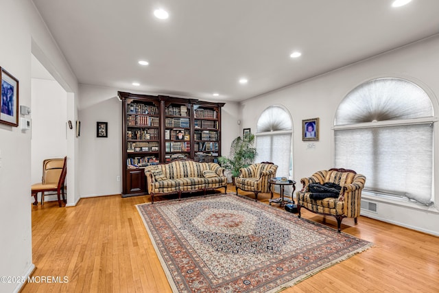sitting room featuring light wood-style floors, visible vents, and recessed lighting