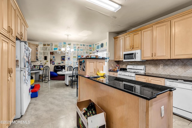 kitchen with light brown cabinetry, white appliances, a chandelier, decorative backsplash, and a kitchen island