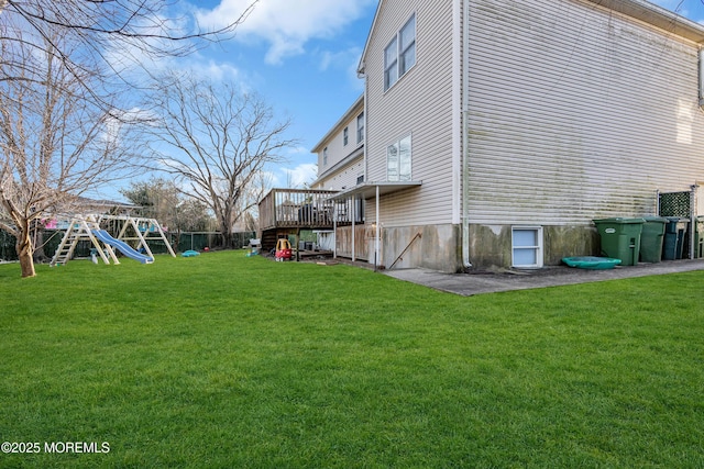 exterior space with a wooden deck and a playground