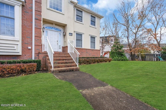 property entrance with a yard