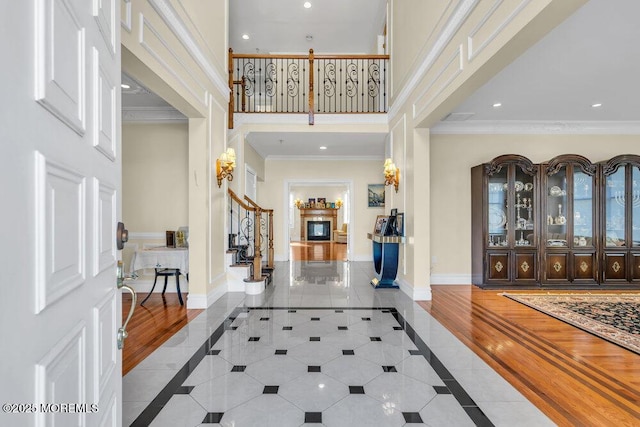 entryway featuring crown molding and a high ceiling