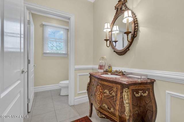 bathroom featuring tile patterned flooring, vanity, and toilet