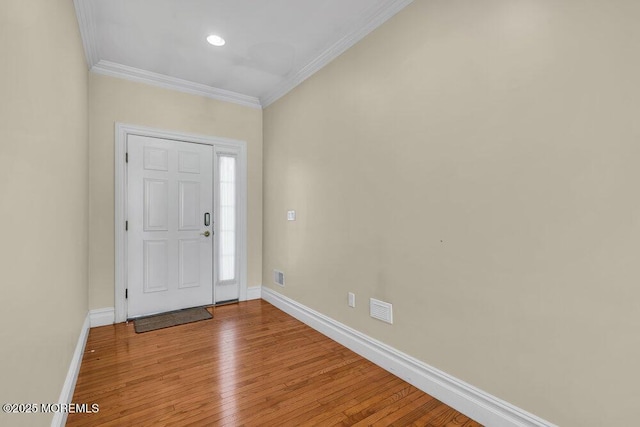 entrance foyer featuring crown molding and light hardwood / wood-style flooring