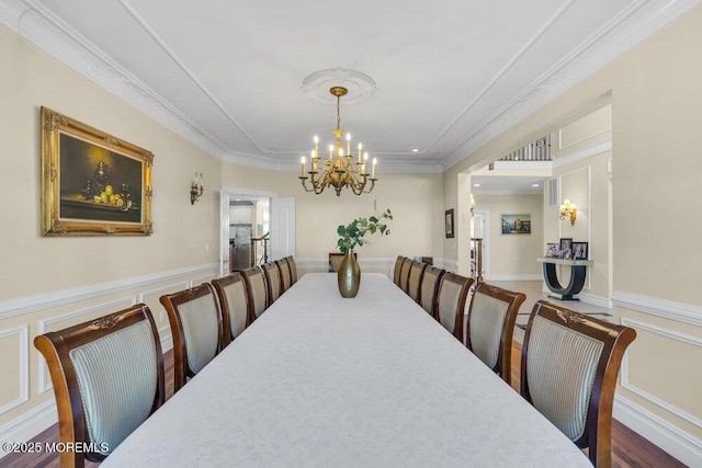 dining space featuring a notable chandelier and ornamental molding