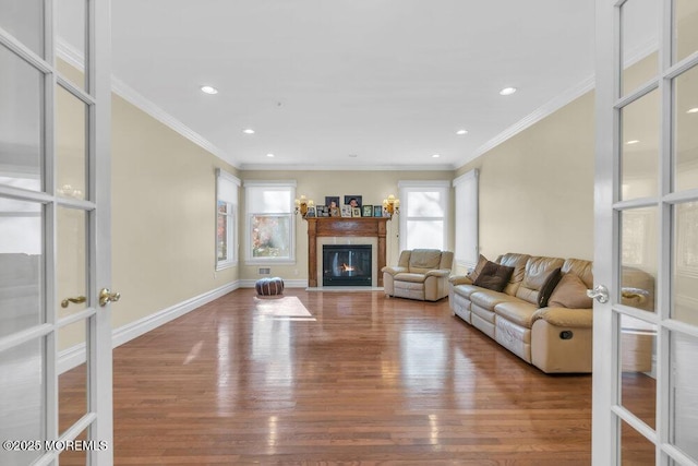 living room with french doors, crown molding, and hardwood / wood-style floors