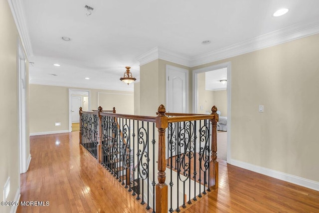 corridor featuring light hardwood / wood-style flooring and ornamental molding