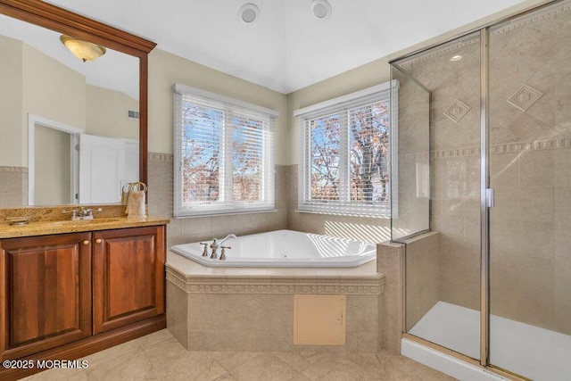 bathroom featuring vanity and shower with separate bathtub