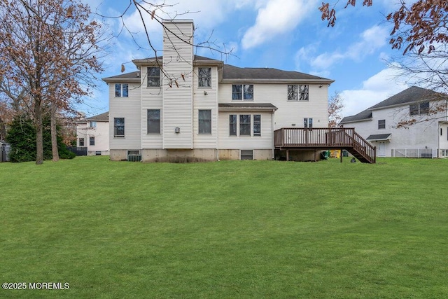 back of property with central AC unit, a yard, and a deck