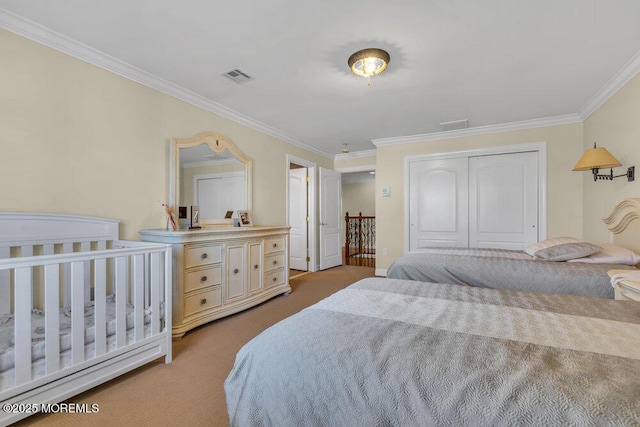 carpeted bedroom with ornamental molding and a closet